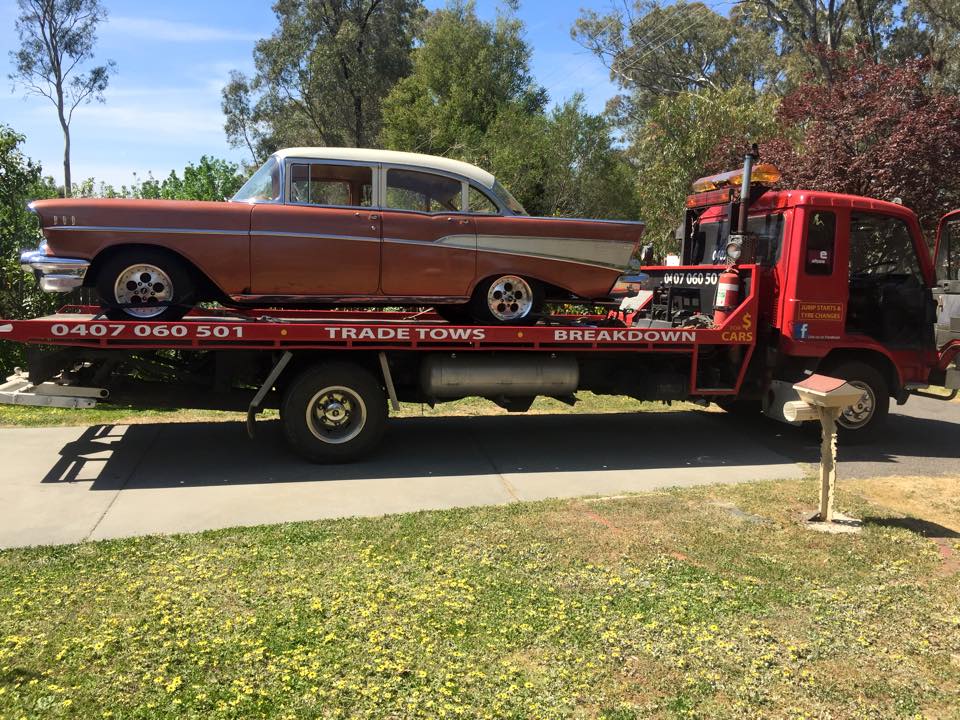 A picture of a brown Cadillac on the Bent and Broke Towing truck